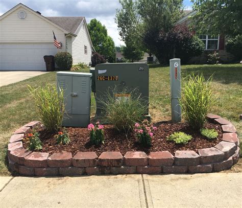 green electric box in yard|landscaping around transformer box.